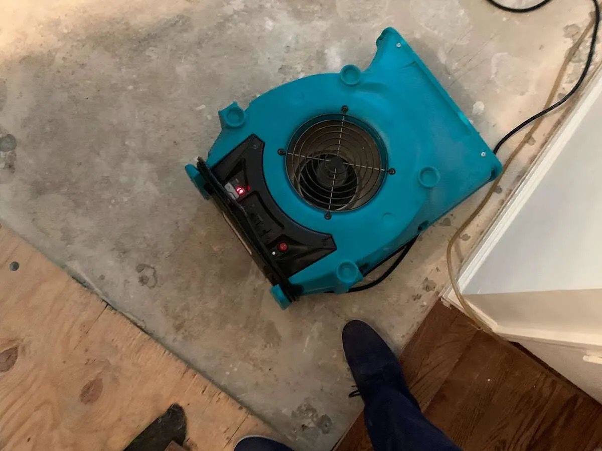 Air mover drying subfloor during Commercial Water Damage Restoration in Kankakee